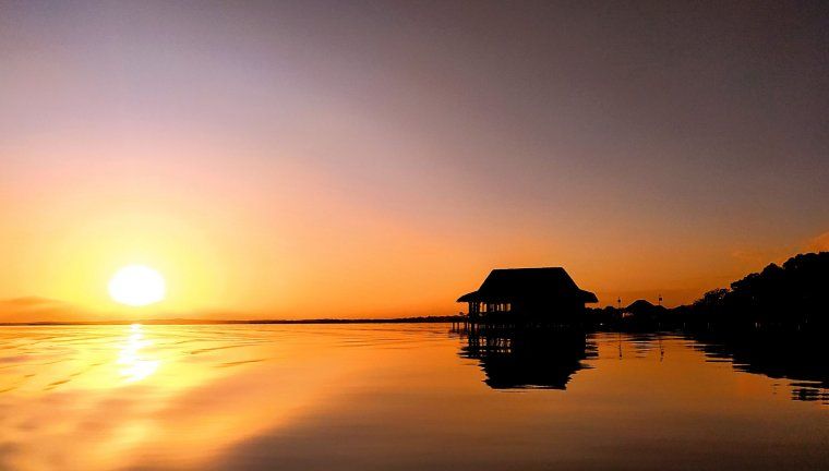 View of stunning sunset and overwater cabin in Bocas del Toro