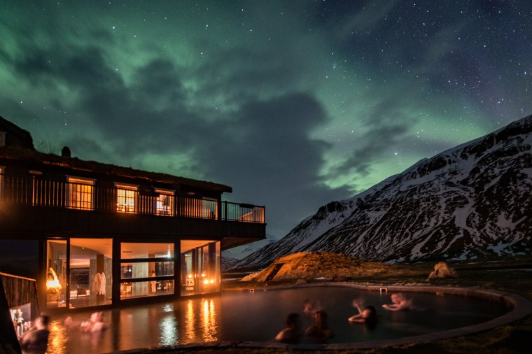 Northern lights over outdoor geothermal pool at Deplar Farm