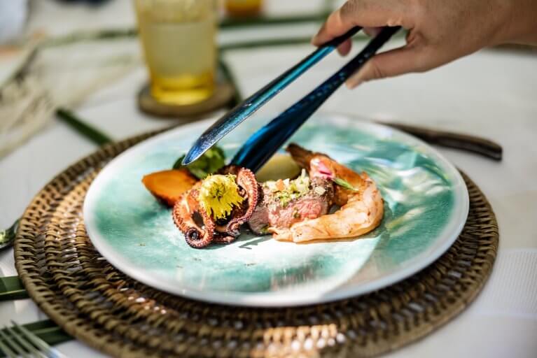 Fresh fish served as part of gourmet dining experience on private island resort on Pacific coast of Panama