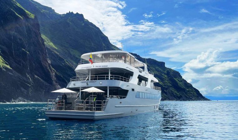 Exterior view of the luxury Tribute Galapagos yacht cruising through the islands during private tour
