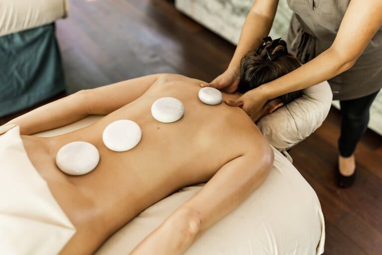 Woman receiving hot stone massage at luxury resort spa in Panama