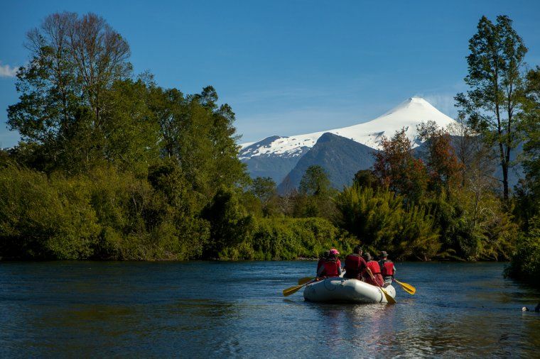 Group on a private boating excursion on the liucura river in the Chilean Lake District in Patagonia