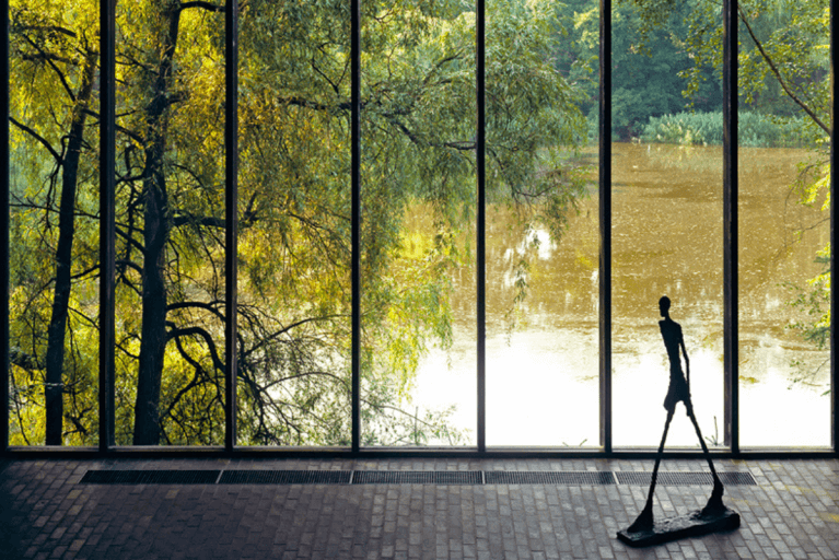Iconic sculpture positioned by a window to a lake at the Louisiana Museum in Copenhagen