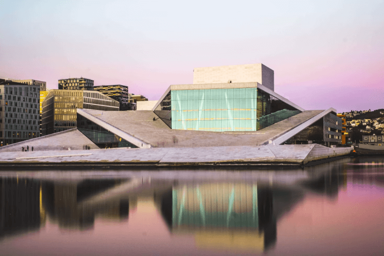Oslo's iconic Opera House lit up at sunset during luxury tour of Norway