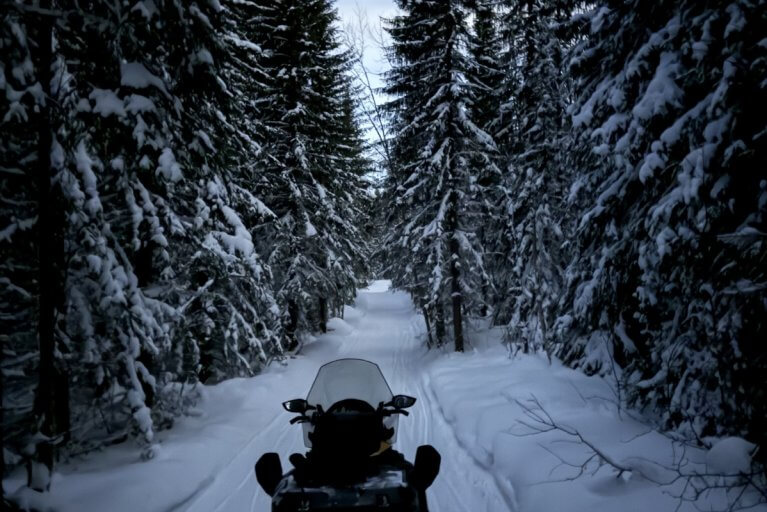Snowmobiling down a wintery path in Alta in Northern Norway