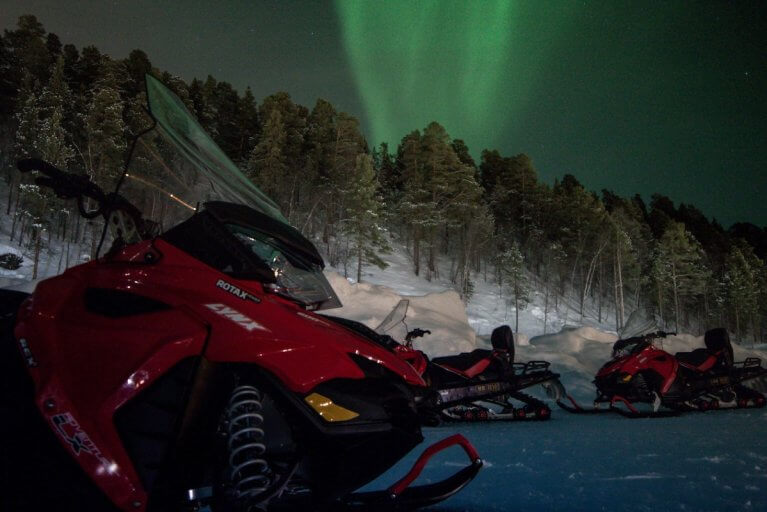 Snowmobile adventure under the northern lights during luxury tour of Alta