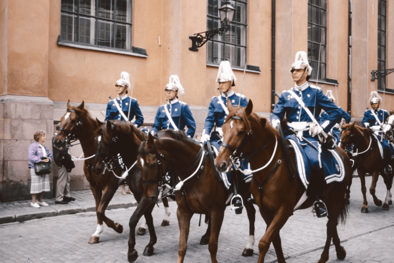 Four guards on horses during Changing of the Guard ceremony in Stockholm outside the Royal Palace during the summer