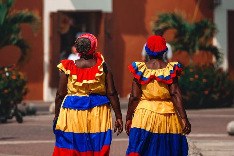 Two women in traditional Colombian dress in the streets of Cartagena