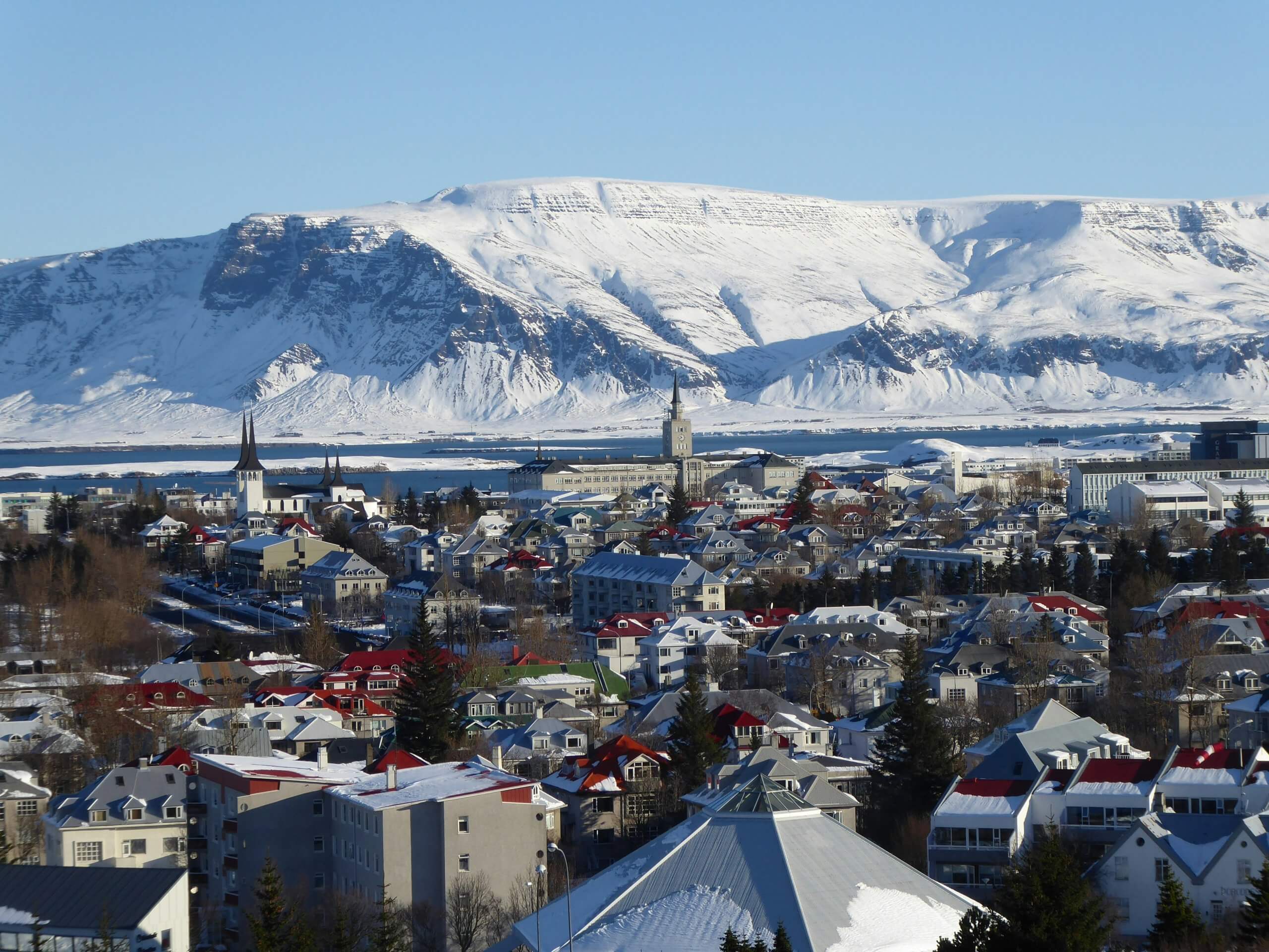 Ice-capped mountains behind Reykjavik in Iceland during luxury winter tour