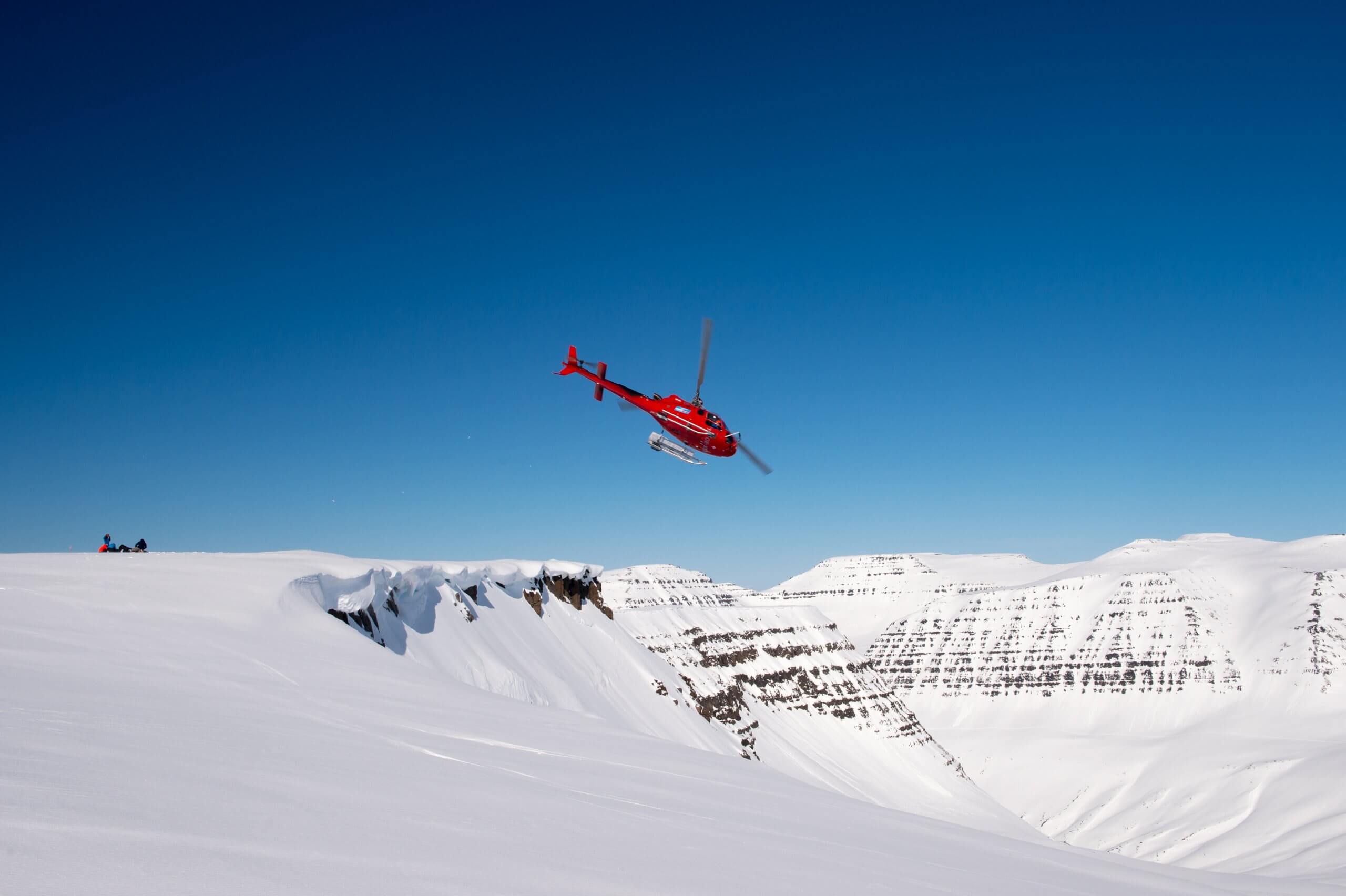 Helicopter flying over Iceland's Arctic landscapes during heli-ski tour