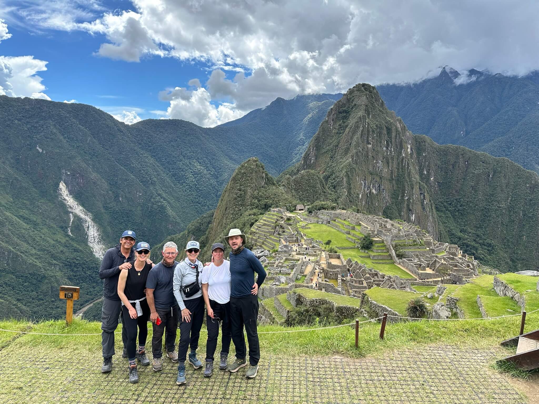 Luxury travelers next to Machu Picchu on luxury private tour