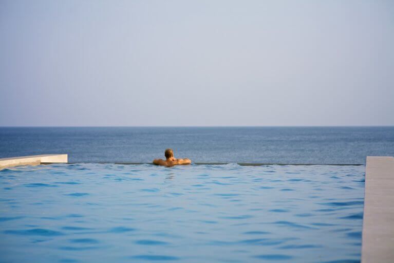 Man enjoying ocean views from pool at private estancia in Azuero Peninsula