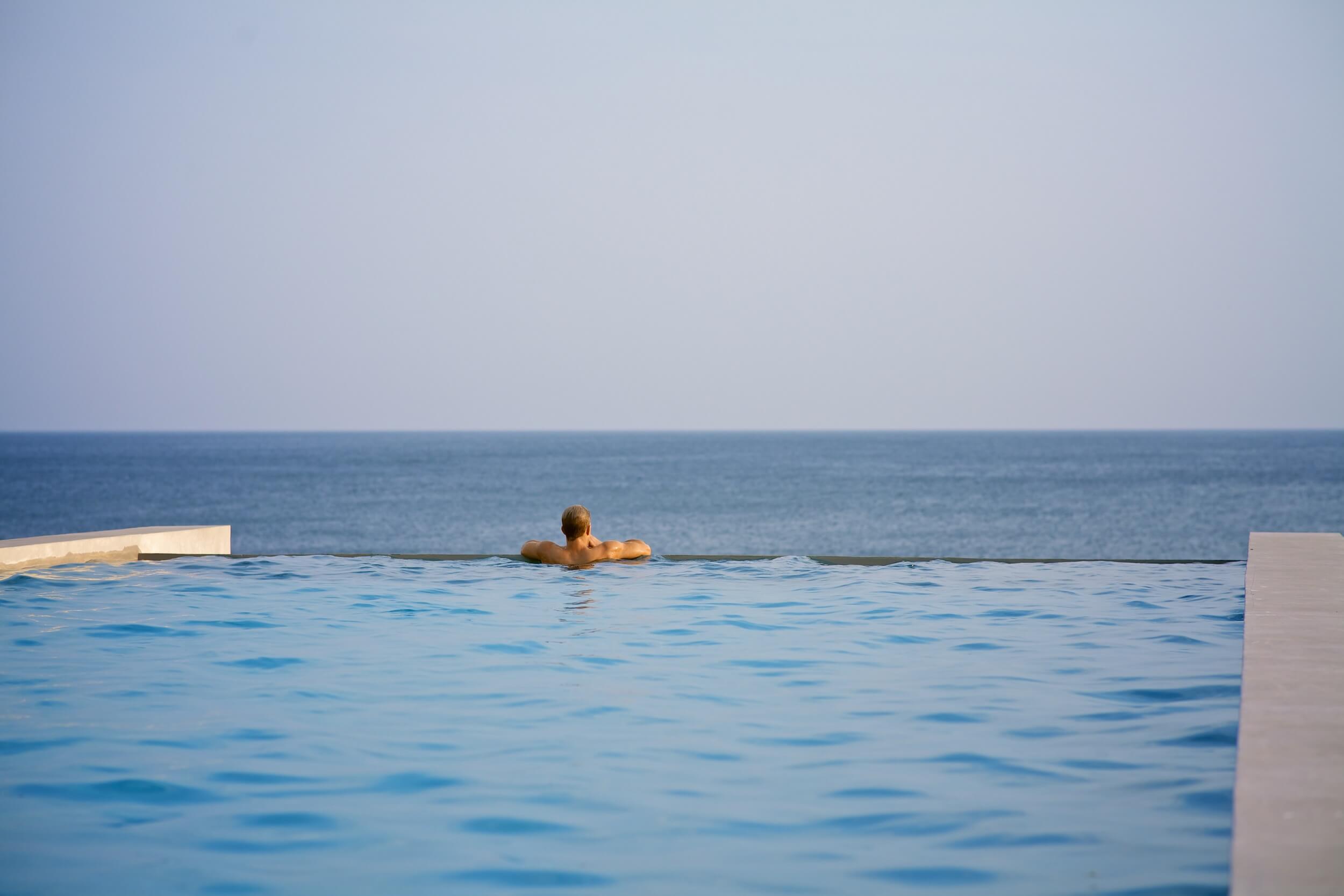Man enjoying ocean views from pool at private estancia in Azuero Peninsula