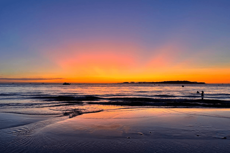 Striking orange sunset over the ocean at Playa La Mansa in Punta del Este