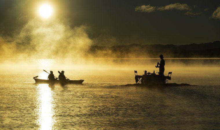 Couple kayaking to a private picnic in the middle of a lake in Bariloche in Argentina