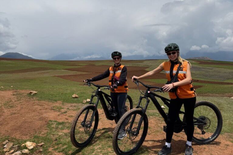 Travelers posing for photo during biking excursion in Peru's Sacred Valley