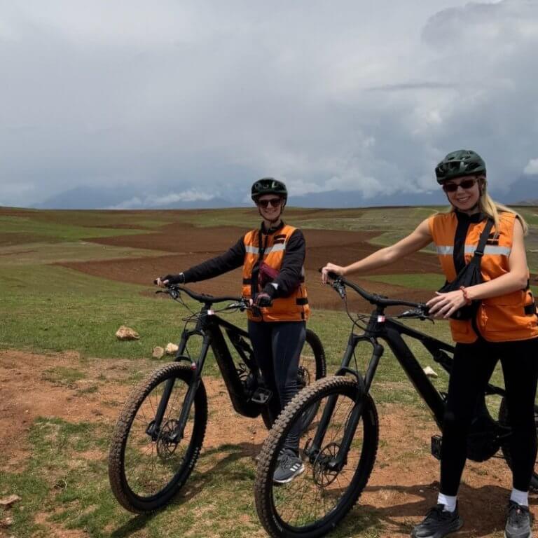 Travelers posing for photo during biking excursion in Peru's Sacred Valley