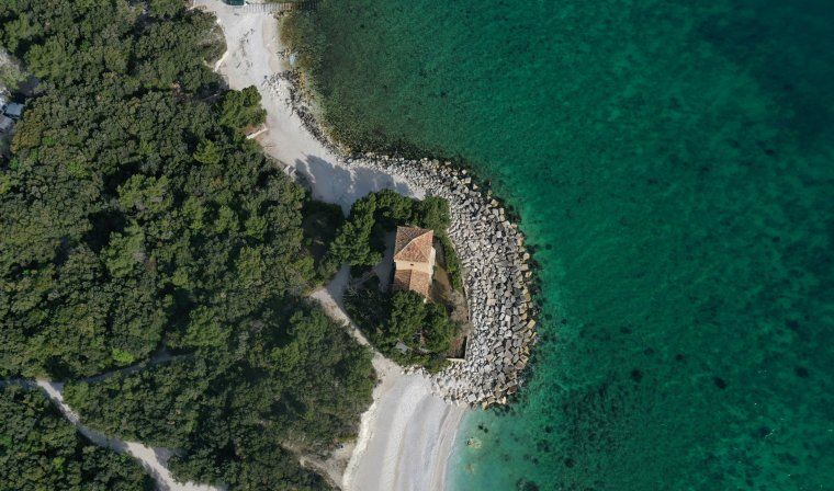 Aerial view of Santa Maria church on the beach of Portonovo in Corsica
