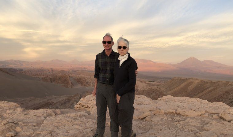 Couple standing on top of a mountain in the Atacama Desert during luxury vacation with Blue Parallel