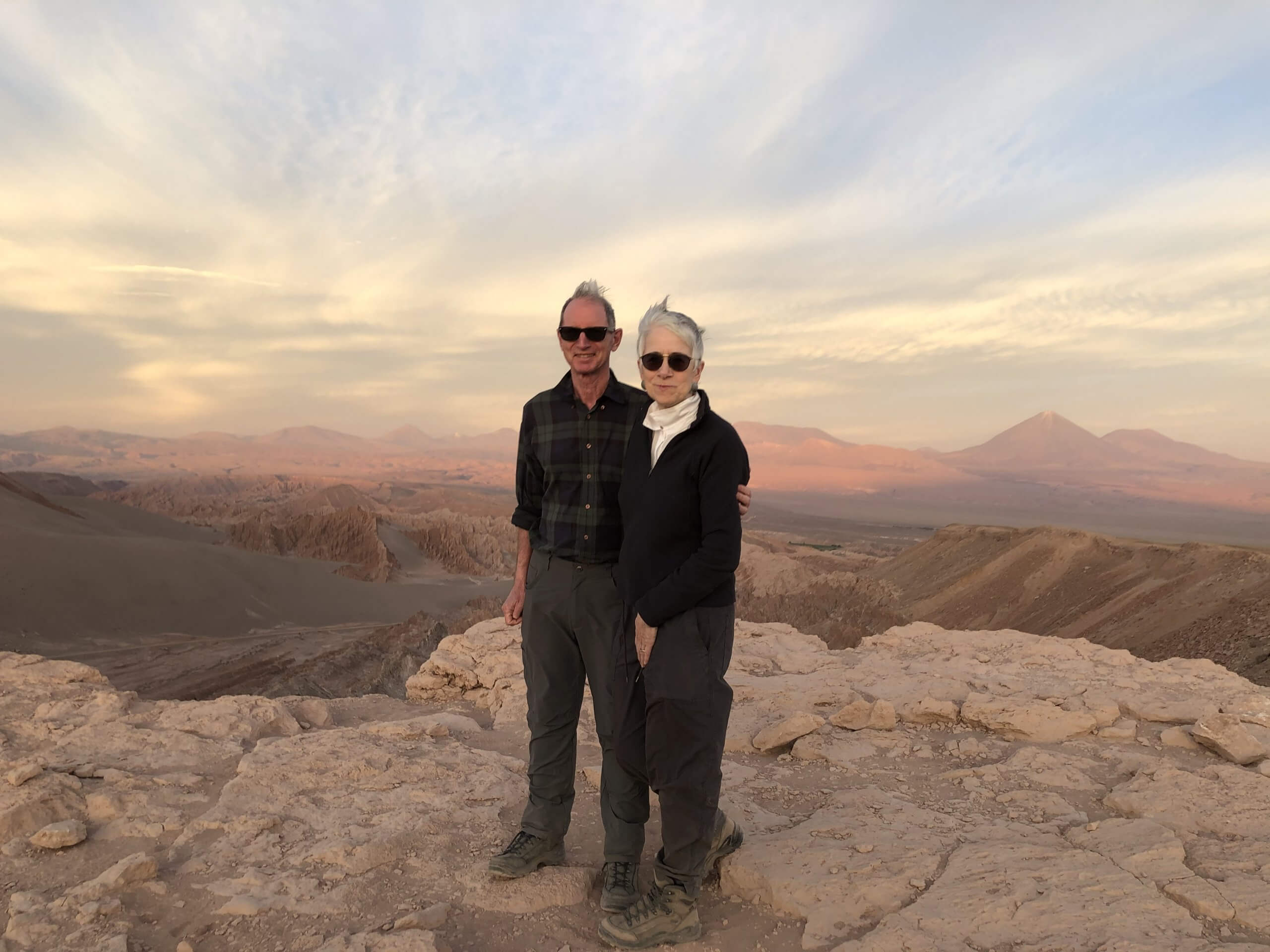 Couple standing on top of a mountain in the Atacama Desert during luxury vacation with Blue Parallel
