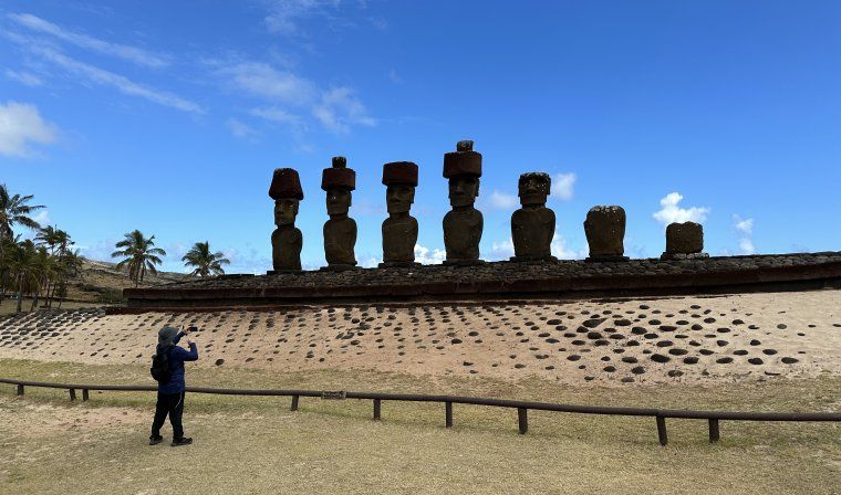 Man taking photos of statues on Easter Island