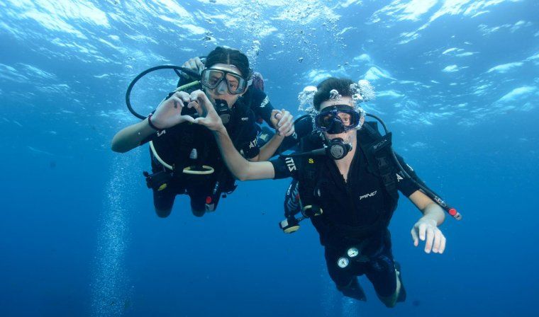 Two people scuba diving on private tour in Fernando de Noronha