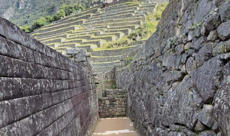 Narrow path in Machu Picchu ruins during luxury tour