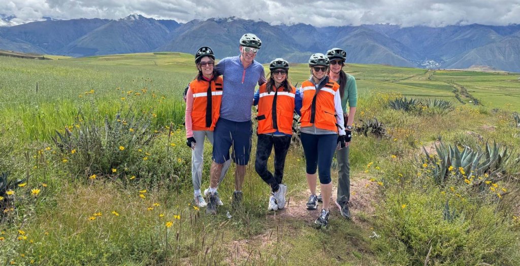 Active bikers standing in the Sacred Valley in Peru following an exciting biking adventure in Peru