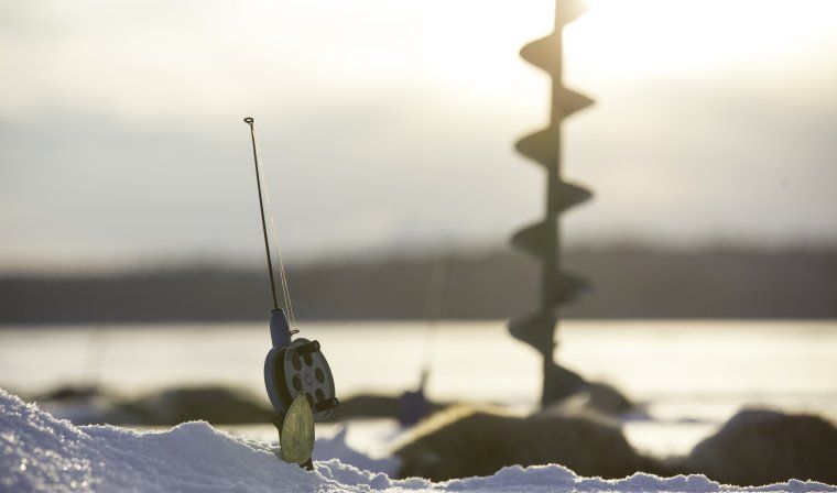 Ice fishing equipment during activity in Swedish Lapland