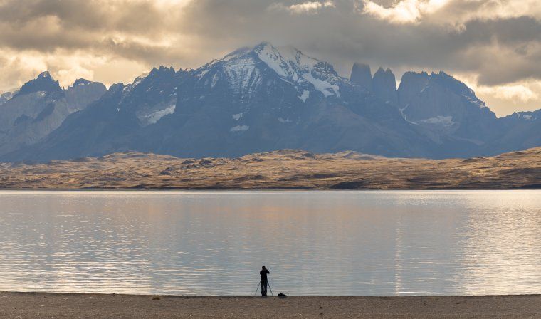 Woman taking pictures of lake in Patagonia during photography experience