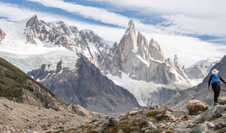 Woman hiking through snow covered mountains in Patagonia during bespoke luxury tour with family