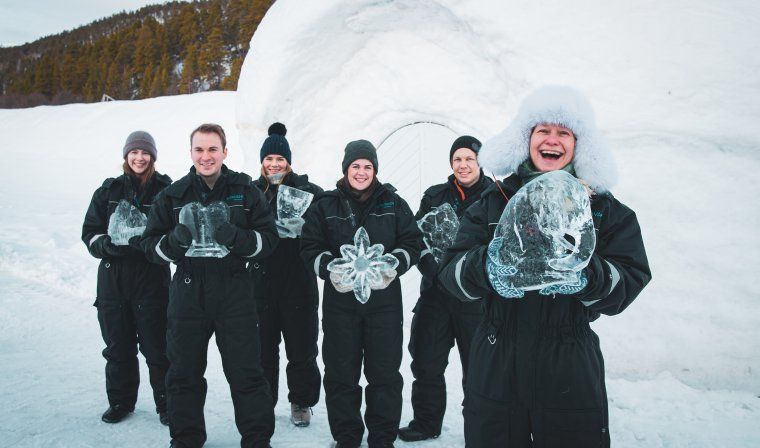 Travelers enjoying private ice sculpting lesson in Alta during private tour of Norway in the winter