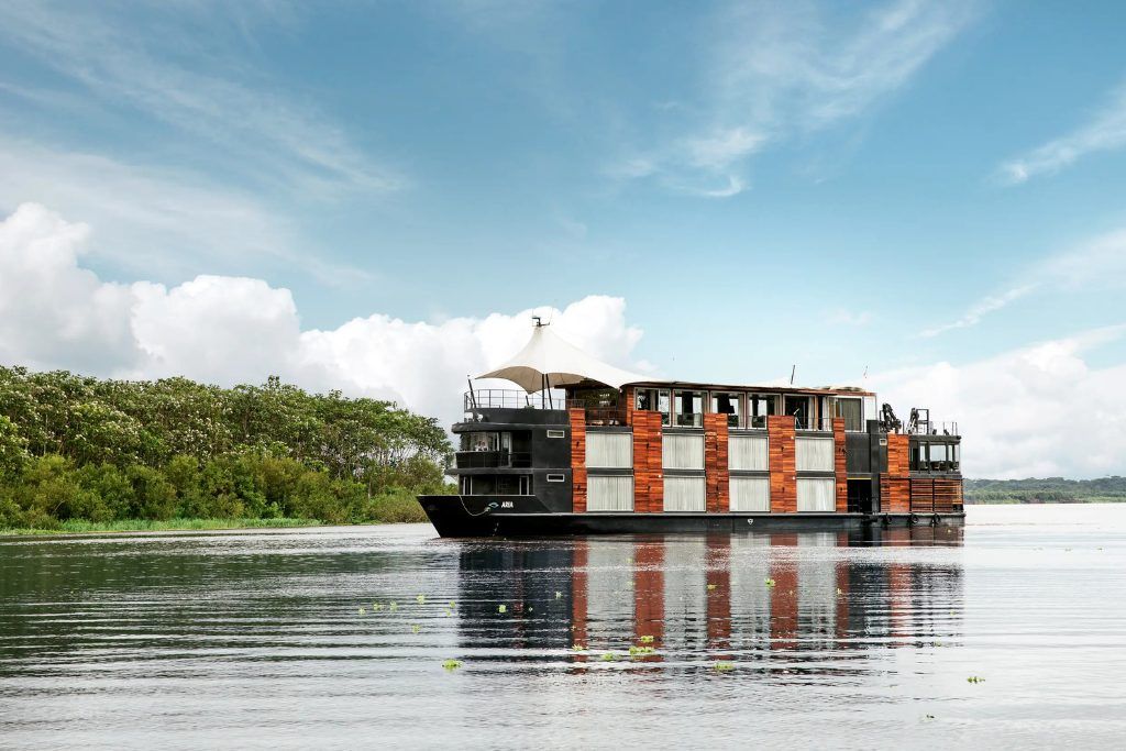Exterior of the luxury Aria boat cruising down the Amazon River during luxury Peru tour