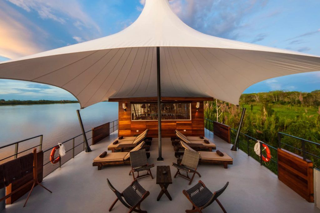 Outdoor deck with views of the Amazon Rainforest from luxury Aria boat in Peru