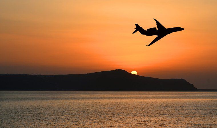 Small private jet flying over ocean in South America during luxury tour