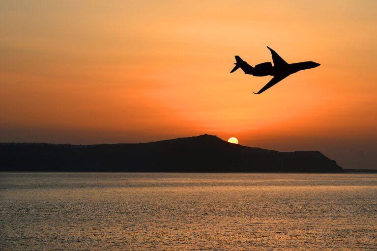 Small private jet flying over ocean in South America during luxury tour
