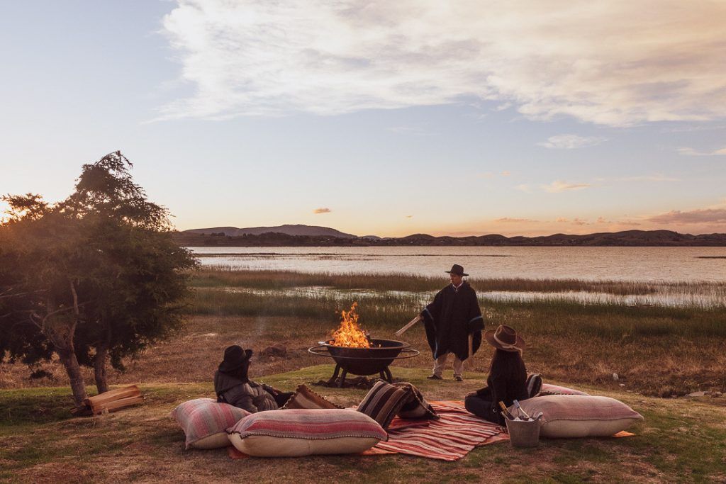 Outdoor fire ceremony on the shore of Lake Titicaca at Titilaka luxury lodge