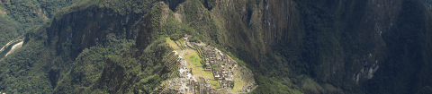 Aerial view of ancient Incan ruins called Machu Picchu surrounded by green Andes mountains including Huayna Picchu