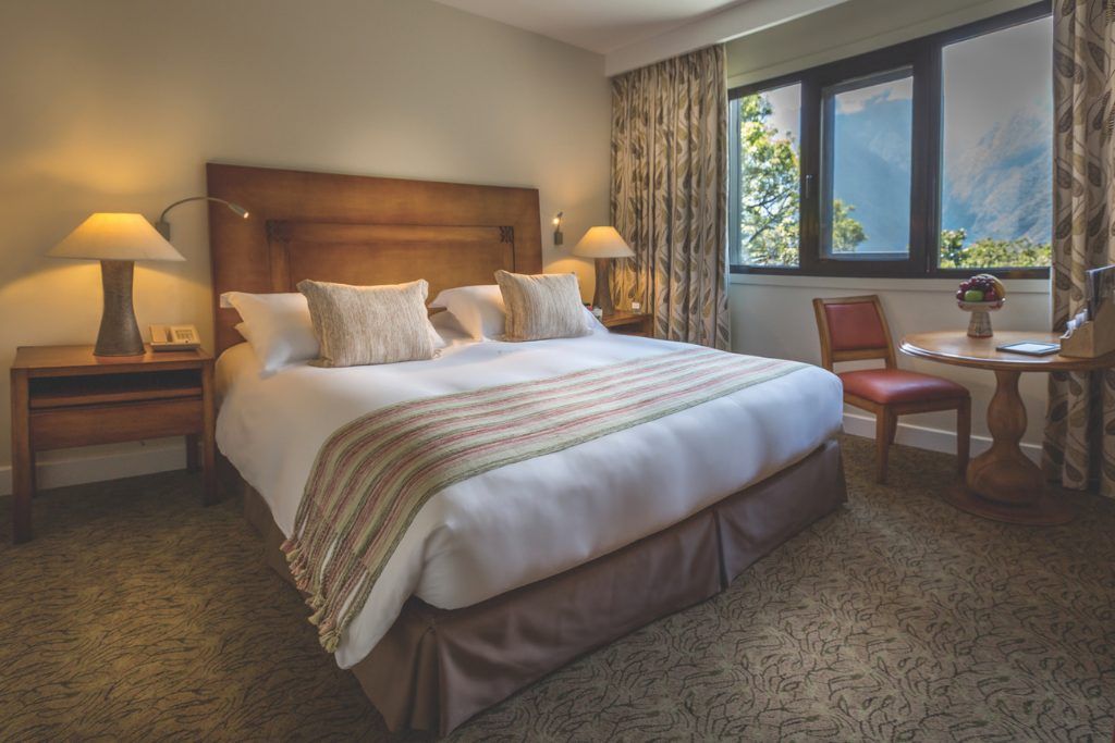 One of the bedrooms at Sanctuary Lodge with views out the window of Machu Picchu.