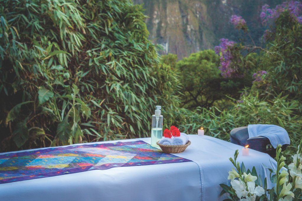 A massage table in a secluded outdoor jungle at the base of Machu Picchu.