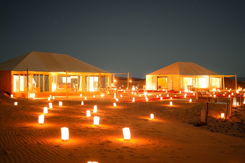 Luxury Desert Camp illuminated with candles at night.