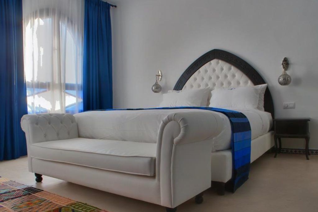 A bedroom with blue accents at Lina Ryad & Spa in Chefchaouen.
