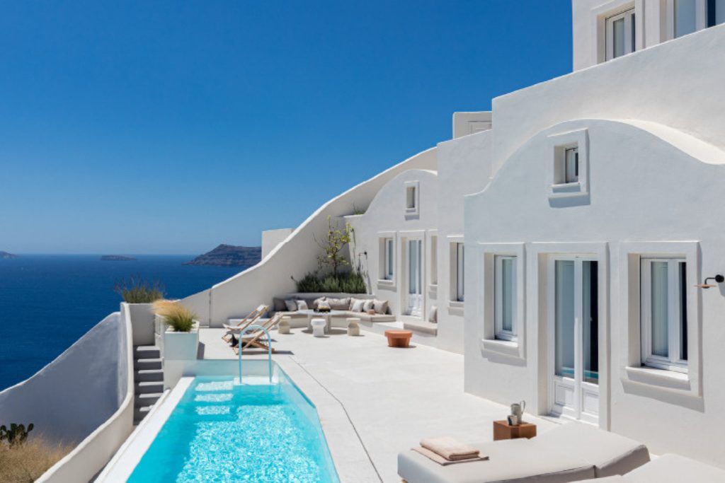 The white-washed exterior of Canavas Oia Suites in Santorini.