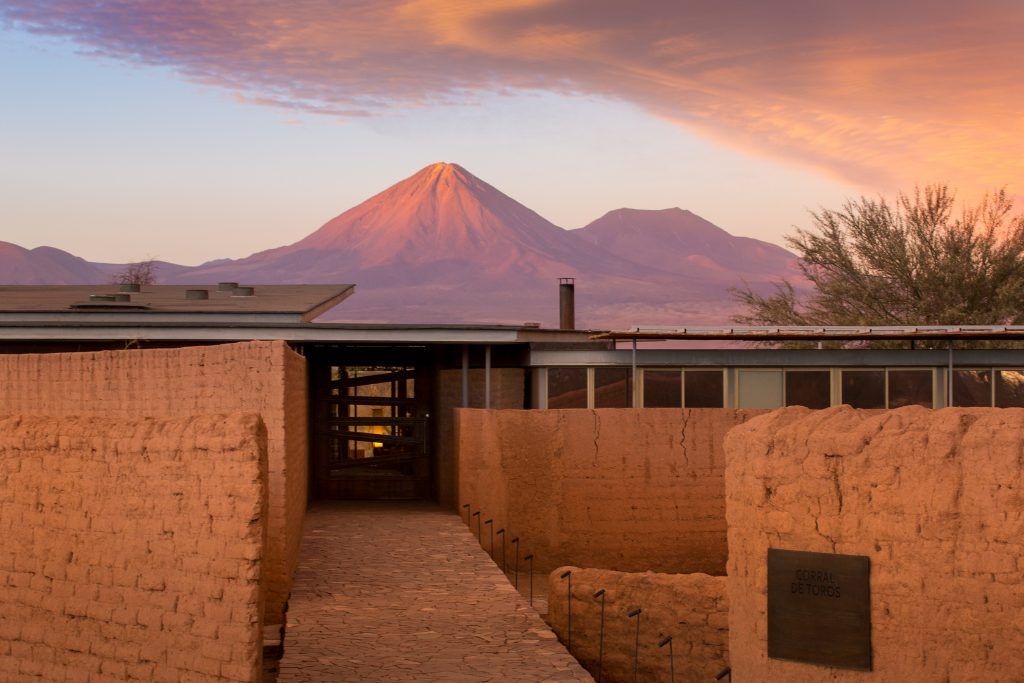 Exterior view of Tierra Atacama Lodge with a mountain in the background.