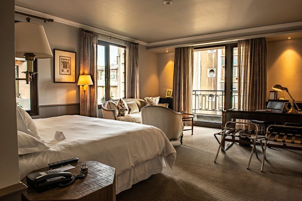 One of the spacious rooms with a balcony and living area at The Singular Santiago.