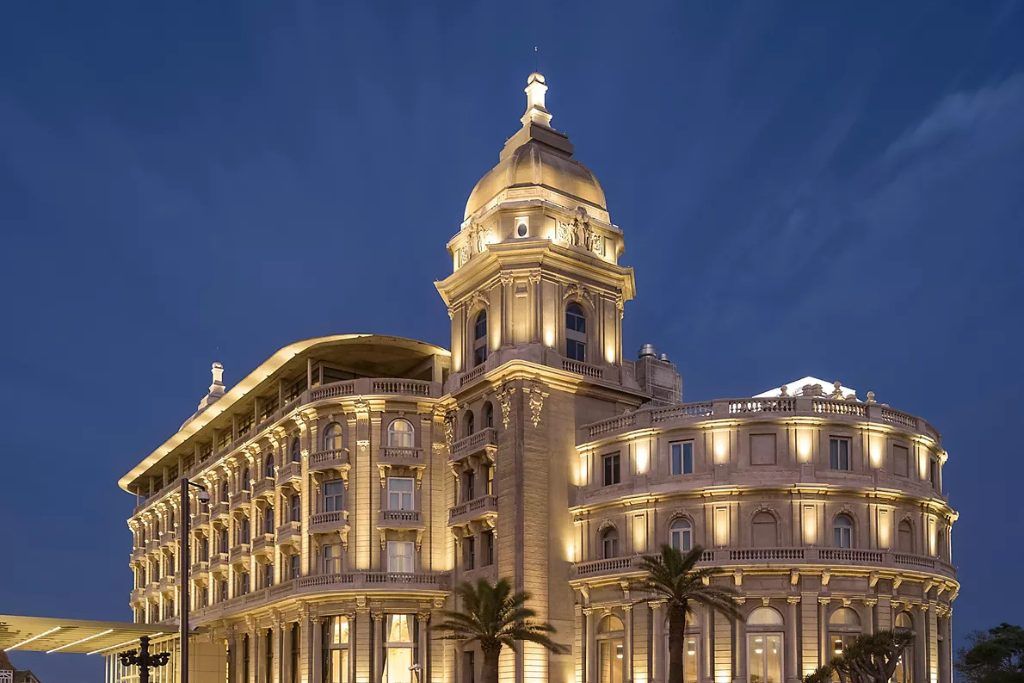 The exterior of the Sofitel Montevideo at night with the windows lit up.