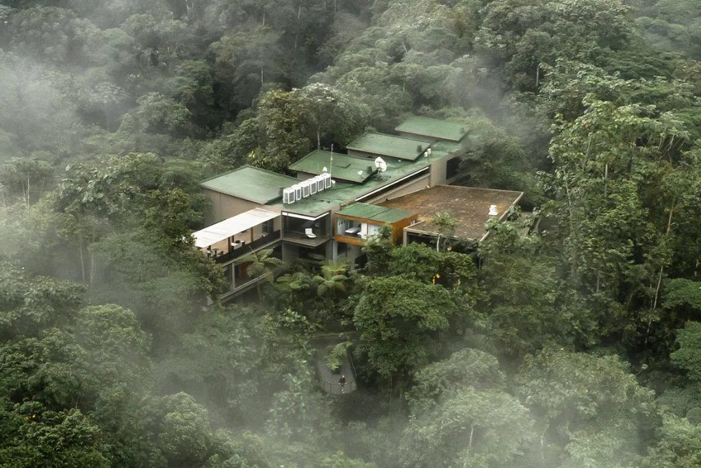 An aerial view of Mashpi Lodge with the clouds.