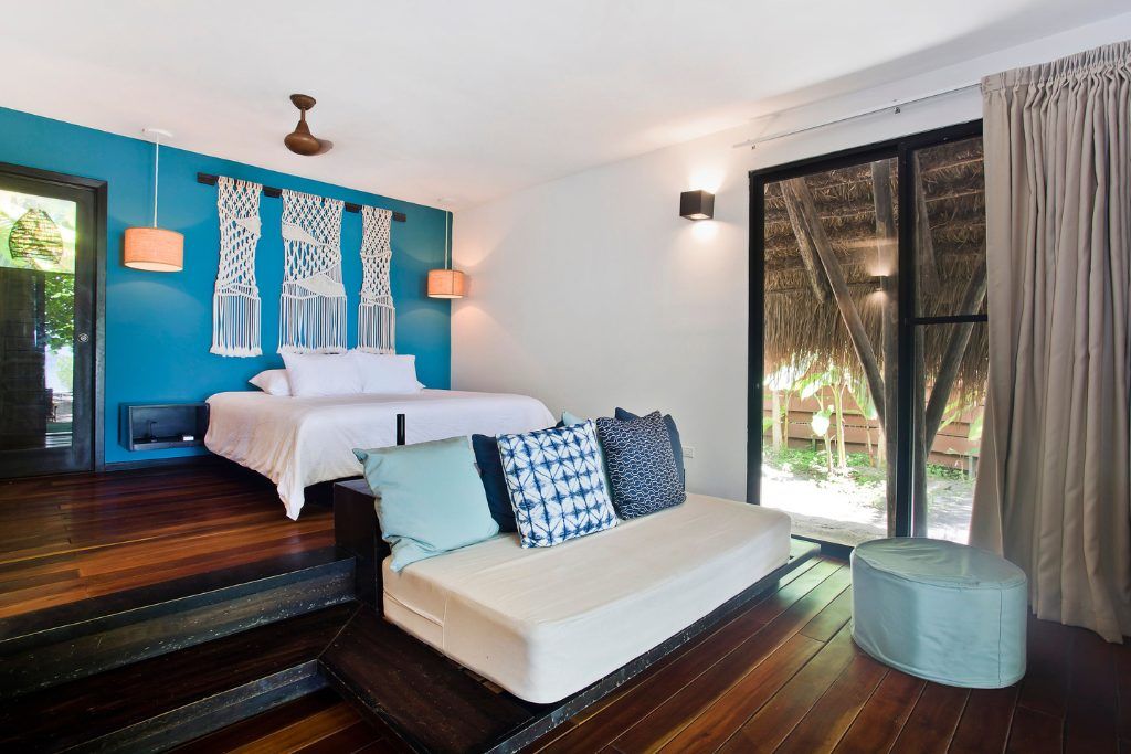 A room with a couch in one of the private bungalows on Isla Palenque.
