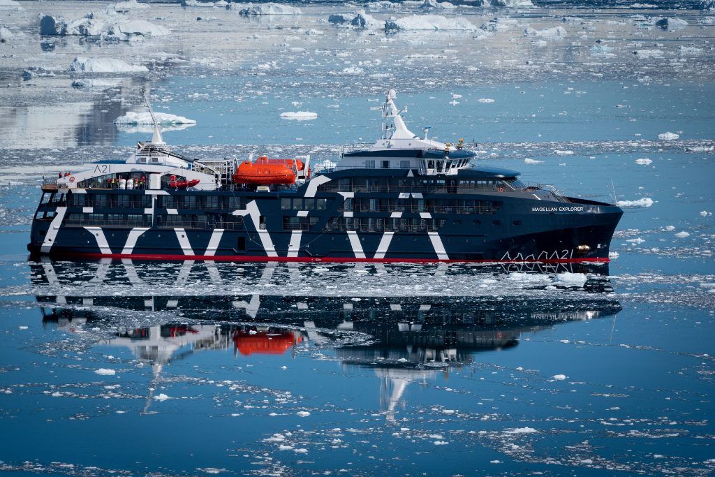 The Magellan Explorer cruising through icy waters in Antarctica.