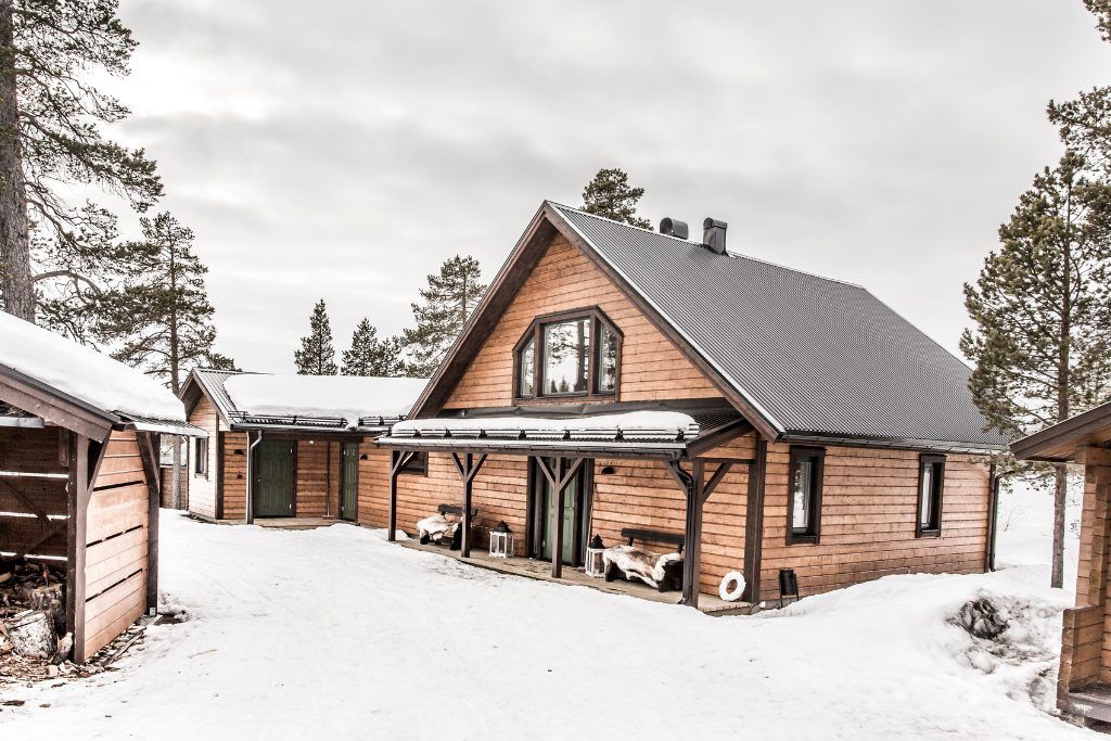 The exterior of Fjellborg Arctic Lodge on a snowy day.